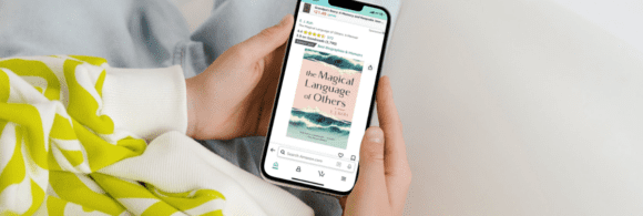 A person looking at the Magical Language of Others on their smart phone.
