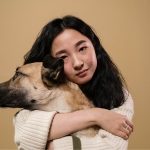 A woman hugging her dog before transferring owndership to a new person in Korea.