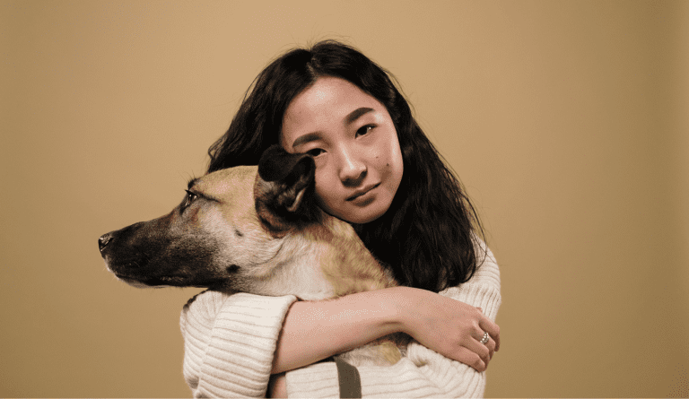 A woman hugging her dog before transferring owndership to a new person in Korea.