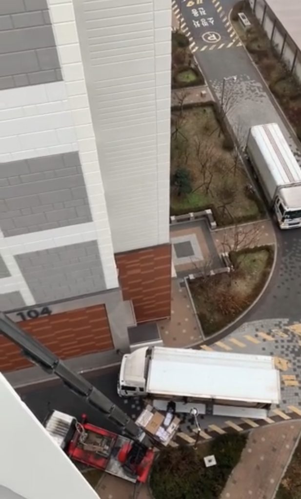 Moving truck parked beside an apartment building in Korea