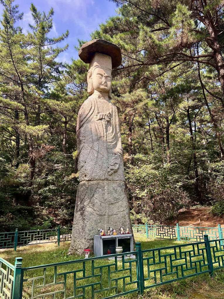 Sapgyo Stone Bodhisattva Standing Statue surrounded by trees in Yesan